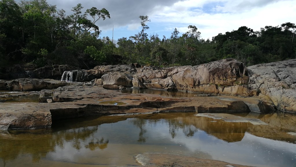 Pools of water with rocks in the background