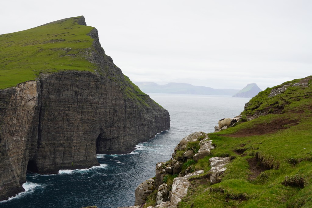 Beautiful view of the ocean and grassy mountains at the edge of the Atlantic Ocean. From Trælanípa, Faroe Islands