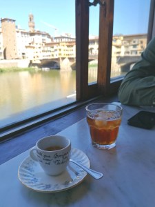 An espresso and ice tea by Ponte Vecchio and Arno River in Firenze, Florence Italy